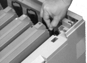 Lightly press the cartridge against the image drum port, then lower the lock lever end,