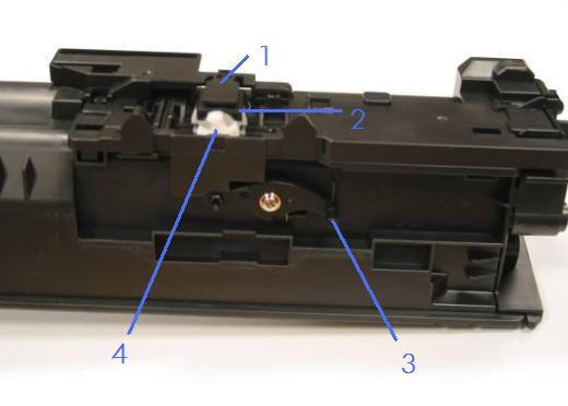1 - Shutter 2 - Toner gate (under the shutter) 3 - Release lever and pin 4 - White gear knob 2. Inspect the bottom area of each toner cartridge for toner contamination.