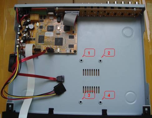 Set the hard drive onto the isolation pads and secure the hard drive to the