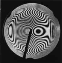 (b) Figure 37.19 This asymmetrical interference pattern indicates imperfections in the lens of a Newton s-rings apparatus.
