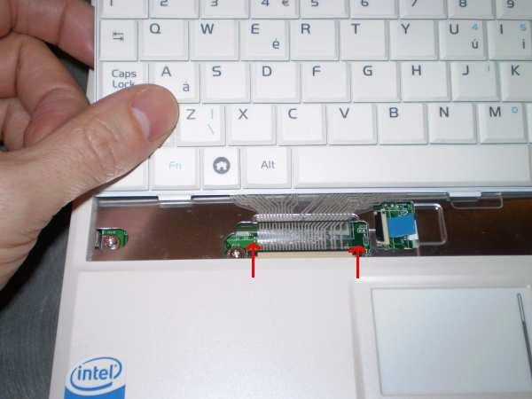 4. Lift the keyboard up and unplug its ribbon cable by pushing the locking connector sides up