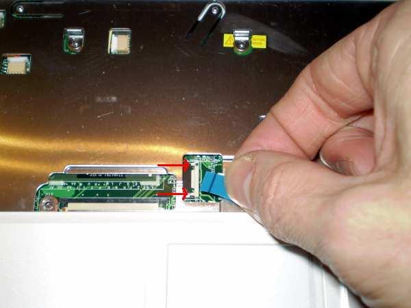 6. Unplug the trackpad ribbon by pushing the locking sides of the