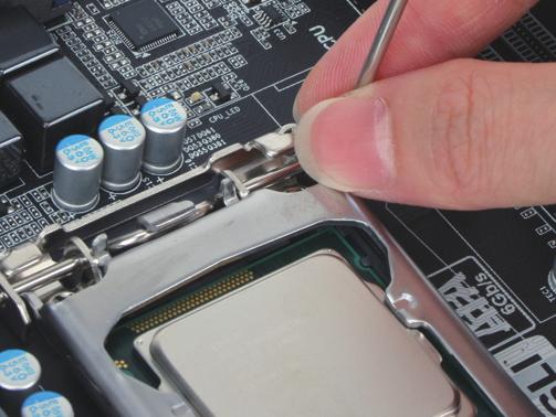 Step 4: Once the CPU is properly inserted, use one hand to hold the socket lever and use the other
