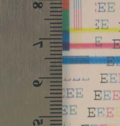 2. Position a metric ruler on the page with the zero ruler mark at one occurrence of the defect (callout 1).