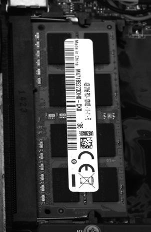 Locate the SO-DIMM memory slot and gently press the two arms securing the memory module