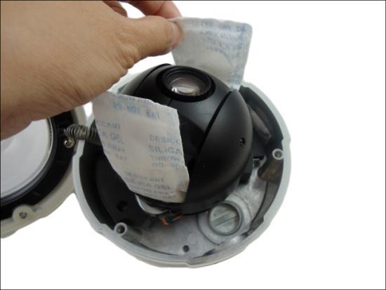 4. Remove the two (2) desiccant bags protecting the camera lens. Do not remove this NOTE: A small desiccant bag is attached to the dome housing (encircled on the above picture).