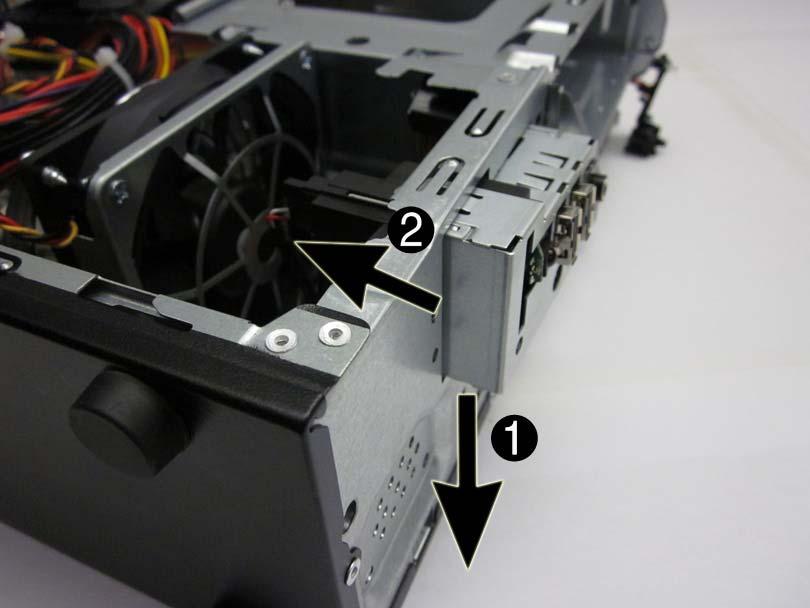 7. Push the left side of the assembly down slightly (1), and then push the assembly into the computer (2). Figure 8-29 Disengaging the front USB assembly 8.
