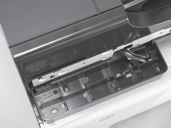 4. At the front of the product, inside the control panel support, remove two screws