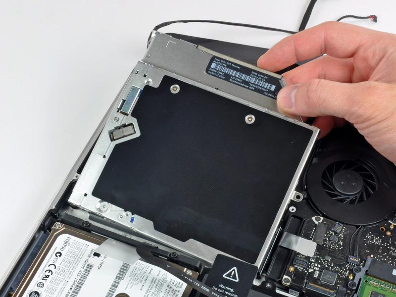 Lift the optical drive from its right edge and pull it out of the