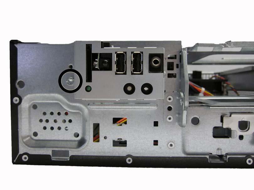 From the front of the computer, remove the screw that secures the assembly to the front