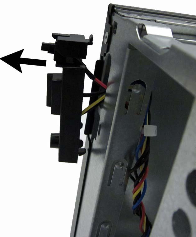 8. Pull the power switch away from the chassis while guiding the wires through the hole in the chassis.