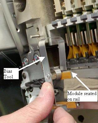 5. Insert both module screws on either side of the carbon window and torque to the value shown in Table 1. Torque the back screw first. NOTE: Do NOT push up on the module screws.