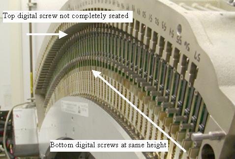 c. Start both screws into the sockets. Thread both screws in together so the cable edge connector is pulled into the backplane straight.