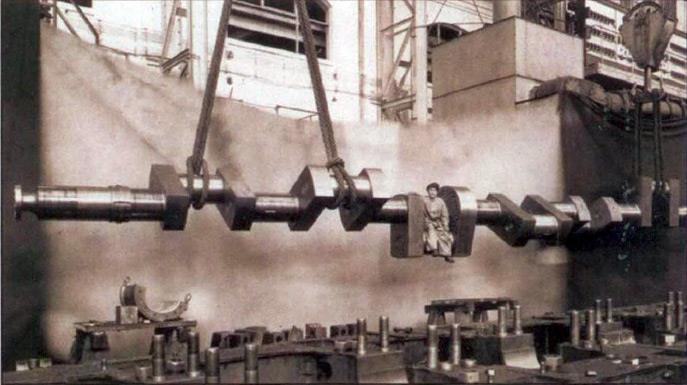 Marine diesel engine crankshaft 1913 - A worker poses
