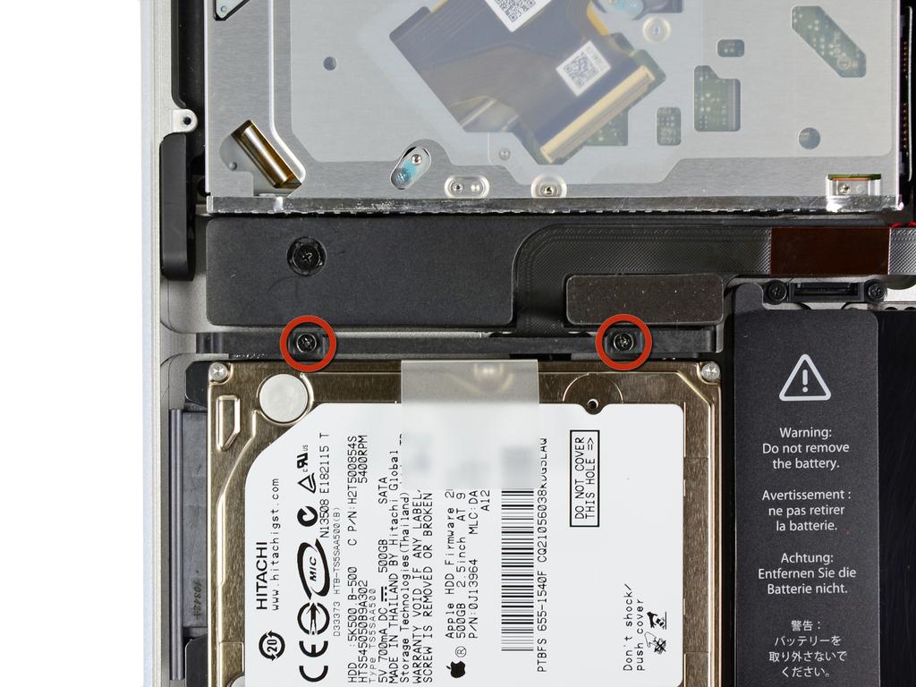 while you work. Remove two Phillips screws securing the hard drive bracket to the upper case.