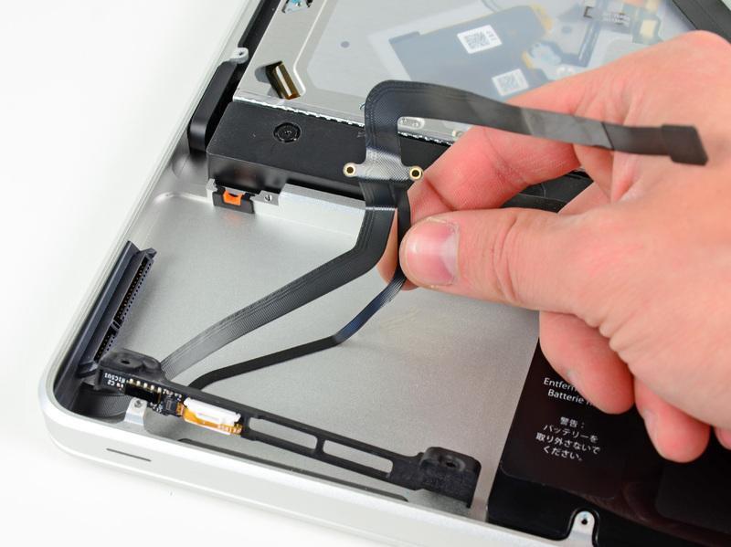 case. Carefully peel the hard drive and IR sensor cable from the upper case.