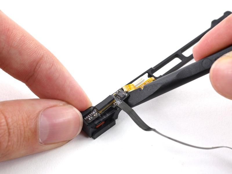 Use the flat end of a spudger to pry the hard drive cable up off the sensor bracket.