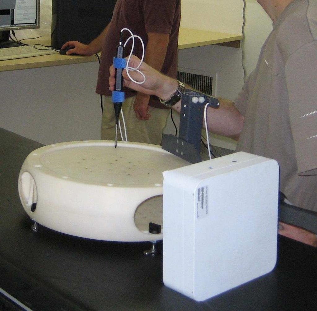 (a) Ring calibration (b) Experiment setup Figure 5.9: Fluoroscopic image registration setup. (a) shows the calibration process of the C-arm ring sensors.