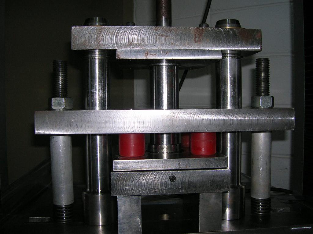 The Figure 8 shows the testing machine and the tools used in the experiments. Figure 8 Tools used in the experiments. The general parameters used in the experiment were: Diameter of punch = 50.