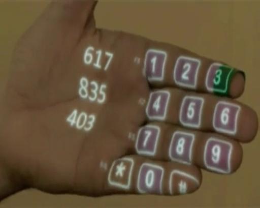 (c) Fig. 14. Example SixthSense device displaying keypad on palm A person coming before this system recognized as student (c) watch on hand. to interact with the machines and computers.