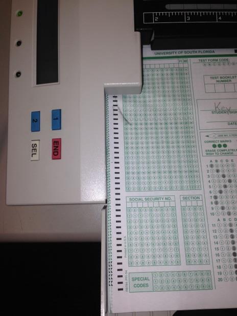 Scantron Operating Instructions Getting Started: 1. Remove the cover and turn on the Scantron machine.