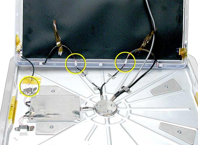 5. Raise the display to disconnect the circled items: The inverter cable, the