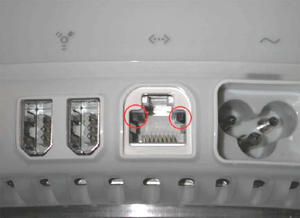 Notice that the port has two metal tabs (circled below) which prohibit the use of a modem cable. 3.