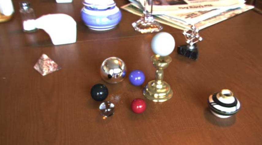 Figure 1: Augmented vision results of Debevec [2]. The six spheres in this image are rendered using lighting information obtained from the real scene.