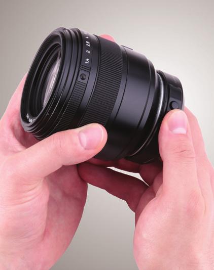 4. Hold down the release button on the adapter mount, and remove the lens by rotating it counterclockwise until it comes to