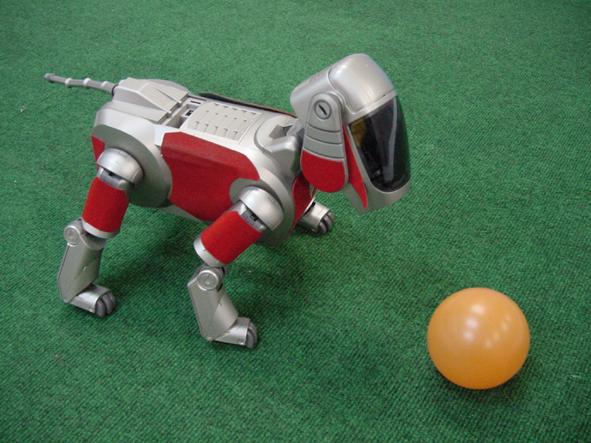 Fig. 2. The legged robot for RoboCup SONY legged robot league (left) and the field (right). 3.
