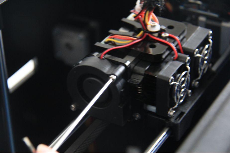 Lower the build plate as much as possible, hold the extruder by both sides, take it out of the