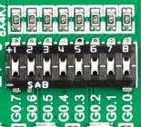 Figure 6-: I/O group contains PORT headers, tri-state pull up/down DIP switch, buttons and LEDs all in one place Tri-state pull-up/down DIP switches Figure 6-: Tri-state DIP switch on GROUP0