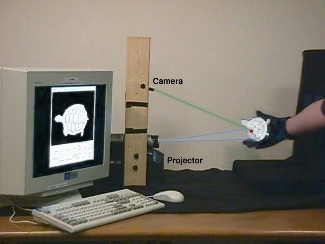 # + Here s what the scanner looks like: it uses a camera and projector in a triangulated-structured-light system, and provides real-time feedback to the user.