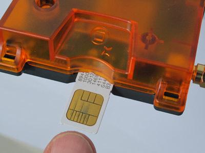 The SIM holder is a push-push type. When inserted far enough, the holder will click and hold the card in position.