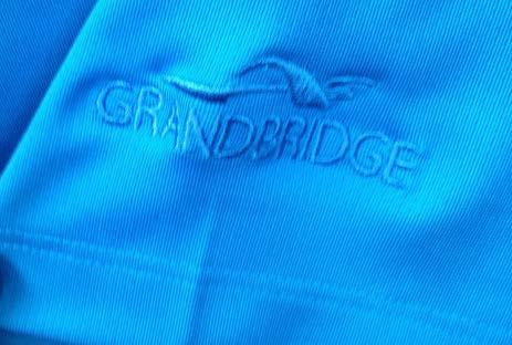 side. Color: Brisk Blue Grandbridge logo embroidered on left