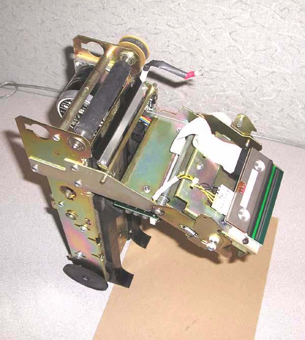 Unimark 8500 Bag Tag Printer 13 Stand the print head/paper stock guide rail assembly in a vertical position on its back end and pour Fedron into the front-end openings of the stock guide rails just