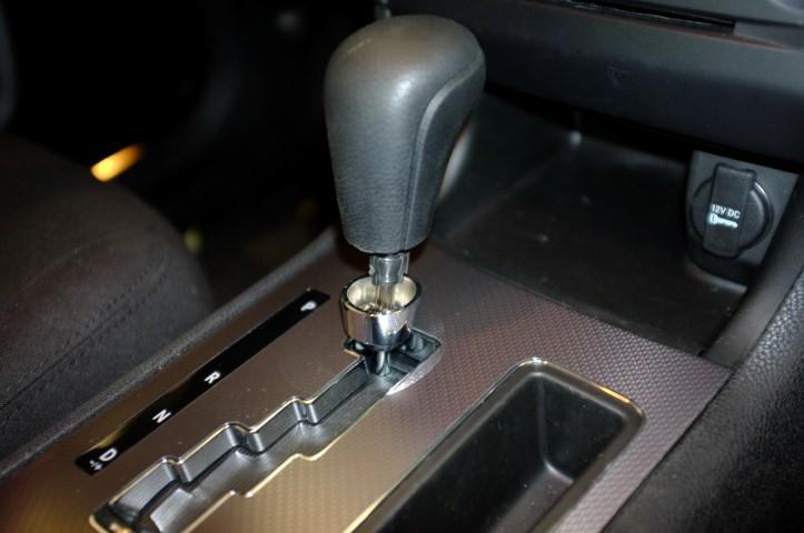 1) Lower the trim collar from the gear shift as shown 2) Remove the small clip