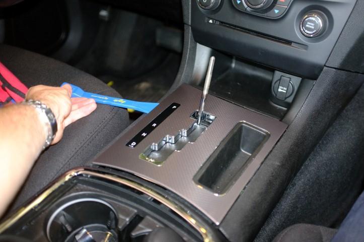 5) Release clips retaining the other side of the trim panel as shown 6) Remove the