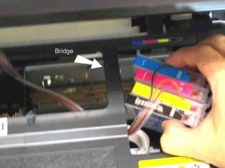 25. With the lid of the printer head off and the air filters installed, you are now ready to insert the cartridges into the printer head. Carefully examine the printers interior before beginning.