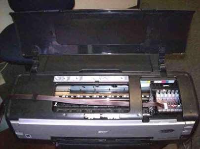 38. With the lid of the printer head off and the air filters installed, you are now ready to insert the cartridges into the printer head. Carefully examine the printers interior before beginning.