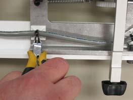 Clip any plastic cable ties that are holding the gray serial cable to the carriage and completely remove the
