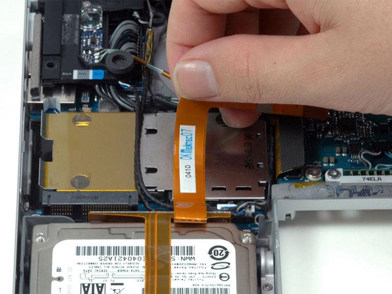 Step 21 Peel up the orange hard drive cable from