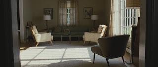 The chair facing inward and it's shadow in the foreground closes the frame along the bottom and