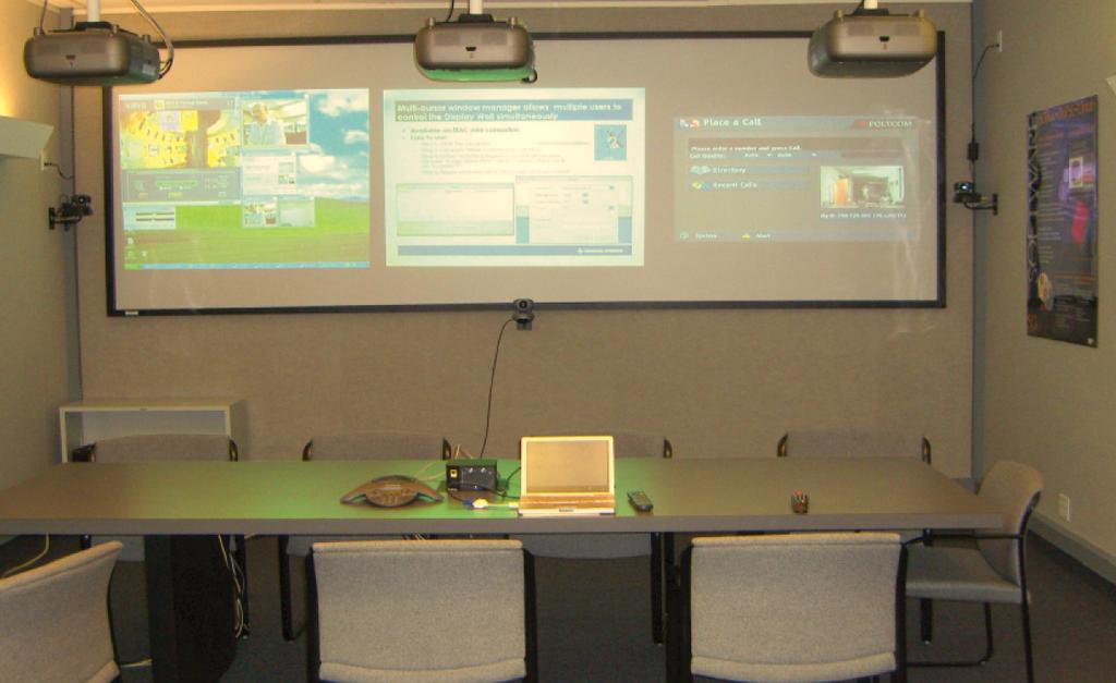 Fig. 3. The three projector screen is shown. On the left, a VRVS-based videoconferencing video is displayed.
