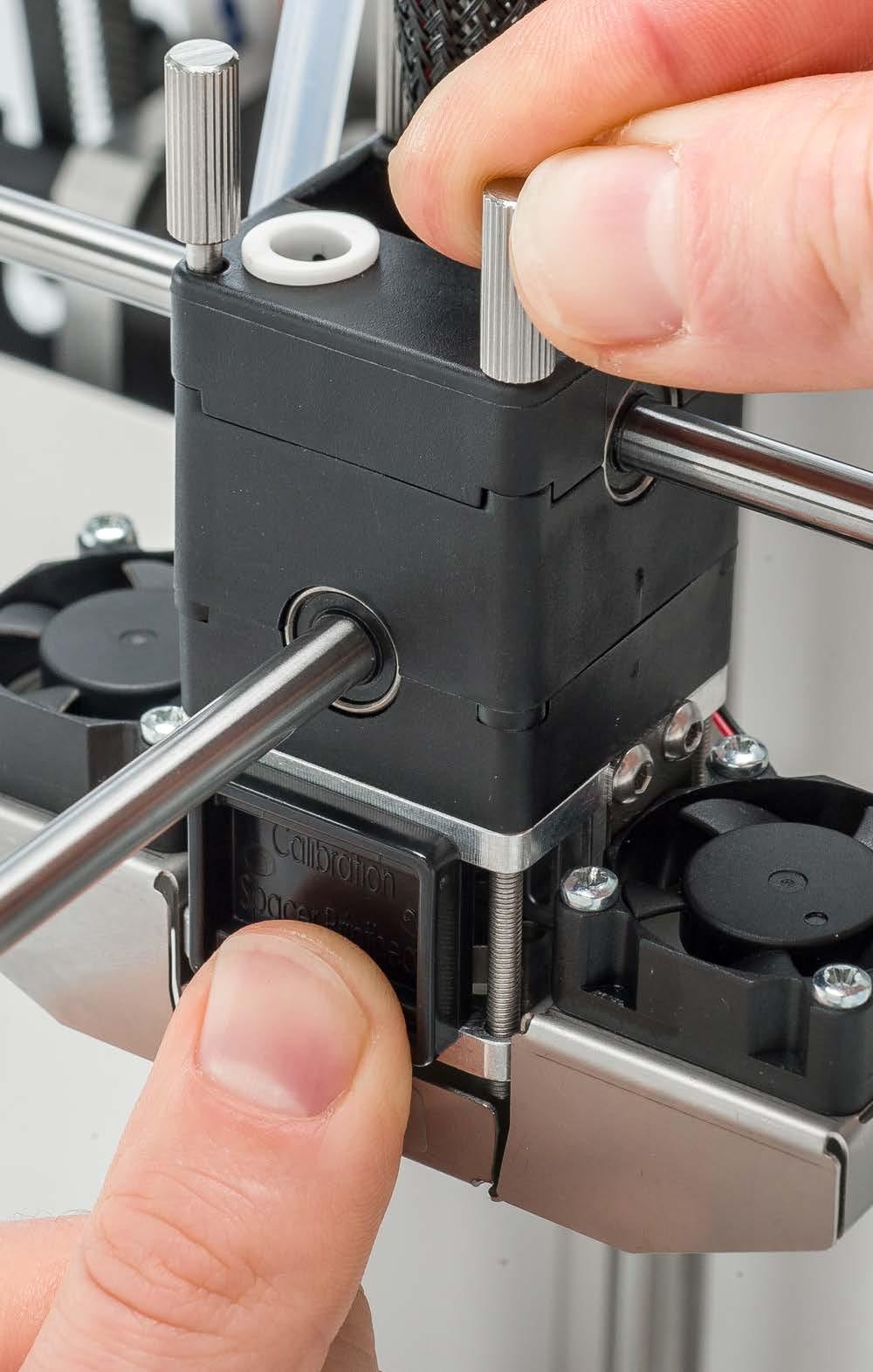 Tighten the front two thumb screws until the tool fits securely between the plates, but can still easily be