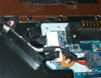 Remove the system board screw by the RAM side of the CPU