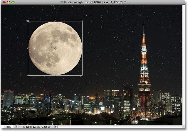 Since the moon is looking a little too big for the second image, I ll press Ctrl+T (Win) / Command+T (Mac) to bring up Photoshop s Free Transform command to resize it, holding the Shift key down as I