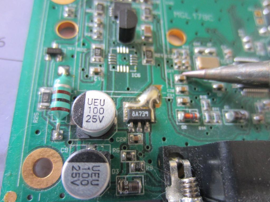 Apply heat to the capacitor until the solder melts and you
