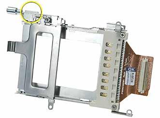 Procedure 1. With the computer on a soft cloth, remove the two screws that attach the PC card cage to the rib frame. (The longer screw is next to the battery connector.) 2.