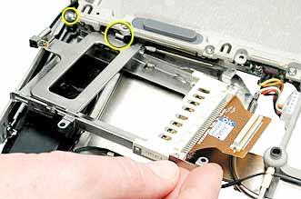 4. When installing the replacement PC card cage, ensure that the metal flange that is closest to the PC card eject button goes underneath the rib frame and